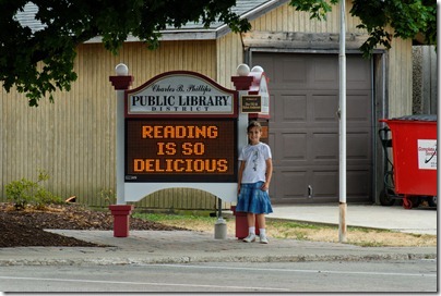 120726136tb Bethany with Library sign, Reading is so Delicious